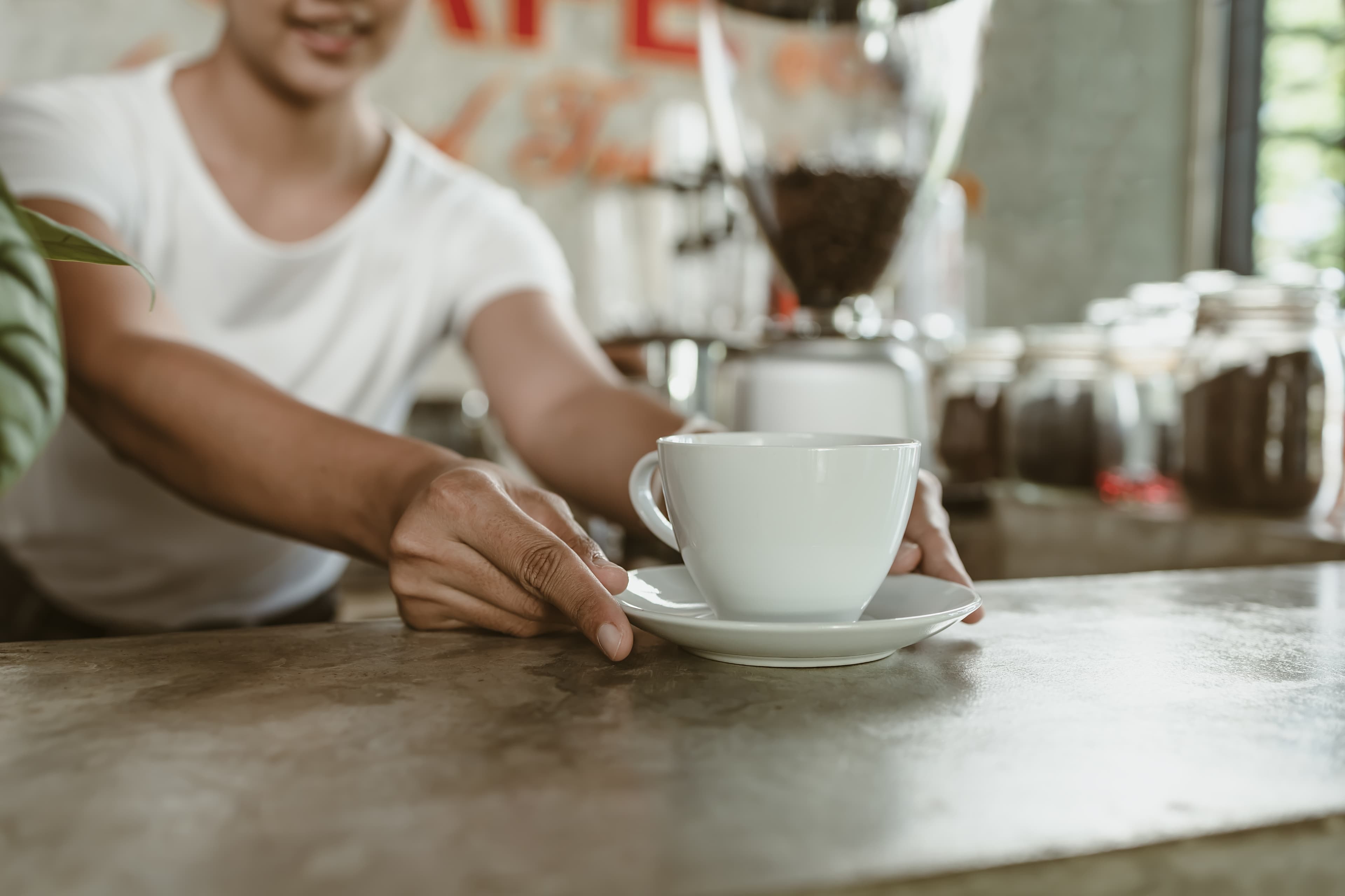 Barista serving coffee at Caffeine Station